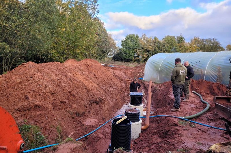 Septic tank installation on a farm in England, with pipework in the trench